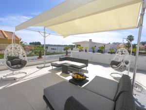 a living room with a couch and chairs on a roof at Luxury Villa Aleana in Portimão