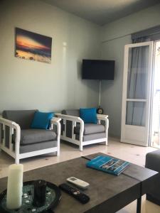 a living room with two couches and a table at Beautiful view of poros in Galatas