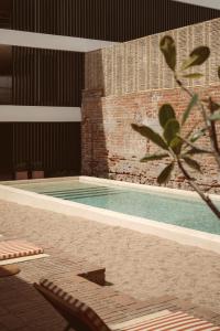 a swimming pool in the middle of a building at Baja Club Hotel, La Paz, Baja California Sur, a Member of Design Hotels in La Paz