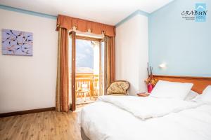 Postel nebo postele na pokoji v ubytování Crabun Hotel