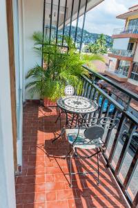 a patio with a table and chairs on a balcony at Hotel Valle in Zihuatanejo