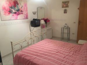 アグローポリにあるVilletta panoramicaのベッドルーム1室(ピンクの毛布、テレビ付)
