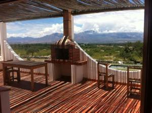 a large deck with a view of the mountains at Hotel Texas in Cafayate