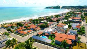 an aerial view of a town next to the ocean at Apart Hotel Litoral Sul in Natal