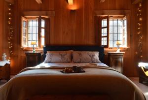 a bedroom with a large bed with christmas lights at LA MURA’ - Il vostro posto nel Gran Paradiso in Ronco Canavese