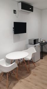 a white table and two chairs in a kitchen at Casa Mo Boutique Guest House in Bloemfontein