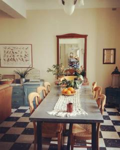 a table with a bowl of fruit on it in a room at Au coin de la Roquette in Arles
