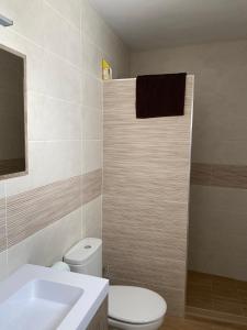 a bathroom with a white toilet and a sink at Casa con vistas 2 in Frigiliana