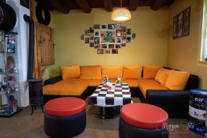 a living room with a couch and a table with stools at Kamarás Ring House in Mogyoród