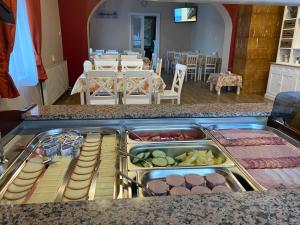 a buffet line with different types of food on display at Kamarás Klastrom House in Mogyoród