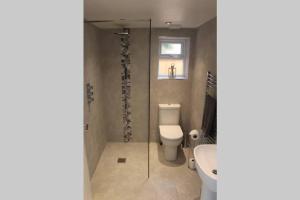 a bathroom with a toilet and a sink at The Coneygree @ Northwick in Worcester +26 photos