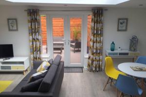 a living room with a couch and a table at The Coneygree @ Northwick in Worcester