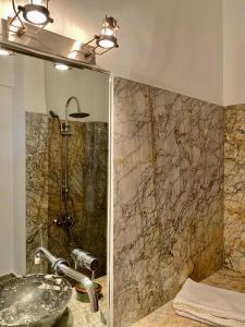 a bathroom with a sink and a shower at La Maison Maure in Fès