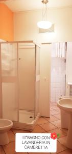 a bathroom with a shower and a toilet and a sink at Casa Genny in Nettuno +42 photos