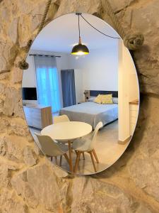 a bedroom with a bed and a table in a mirror at Apartaments l'Escala Centre in L'Escala