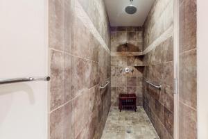 a walk in shower with a glass door at Diamond Beach Condos in Galveston