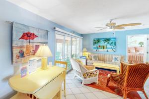 a living room with a table and chairs at 21 Palms in Anna Maria