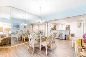 a dining room and kitchen with a table and chairs at Barrington Arms 208 in Hilton Head Island