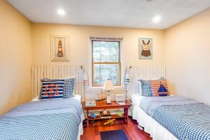 Habitación con 2 camas individuales y mesa. en Brewster House en Oak Bluffs