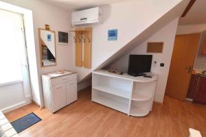 a room with a desk with a computer and a staircase at Apartment in Veli Losinj 15050 in Veli Lošinj