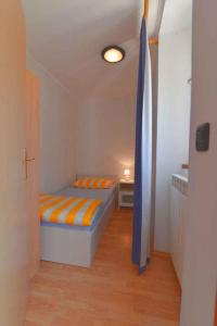 a small bedroom with a bed in a room at Apartment in Veli Losinj 15050 in Veli Lošinj
