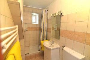 a bathroom with a white toilet and a sink at Apartment in Veli Losinj 15050 in Veli Lošinj