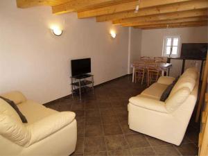 a living room with two white couches and a television at Apartments in Veli Losinj 14994 in Veli Lošinj