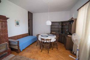 a room with a table and a bed and a kitchen at Apartment in Veli Losinj 34684 in Veli Lošinj