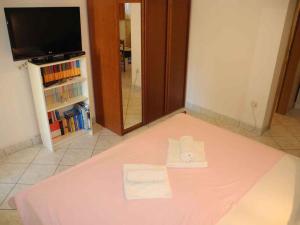 Una cama en una habitación con una sábana rosa. en Studio in Crikvenica 13840 en Crikvenica