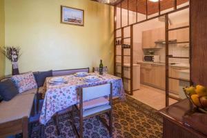 a living room with a table and a kitchen at Apartment in Vrbnik/Island Krk 35825 in Vrbnik