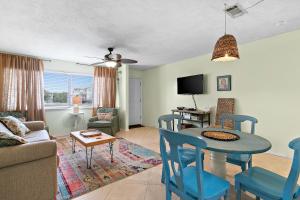 a living room with a table and chairs and a couch at Sunny Daze in Navarre