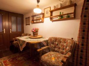 a living room with a table and a chair and a table and a chair at Holiday home in Mühlbach im Pinzgau 35597 in Bicheln +16 photos