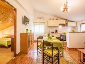 a kitchen and dining room with a table and chairs at Apartment in Vrbnik - Insel Krk 13622 in Vrbnik