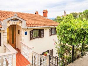 a white house with a gate and a fence at Apartment in Vrbnik - Insel Krk 13622 in Vrbnik