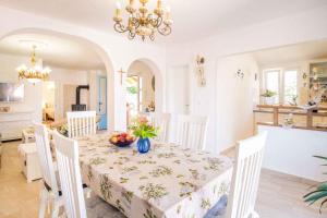 a white dining room with a table and chairs at Holiday home in Vrbnik/Insel Krk 13634 in Vrbnik