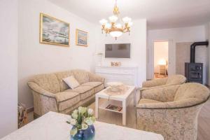 a living room with two couches and a table at Holiday home in Vrbnik/Insel Krk 13634 in Vrbnik