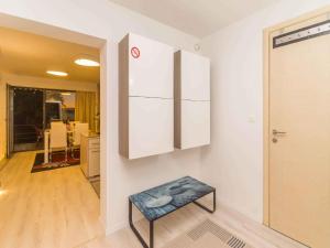 a room with a table and a wall with white cabinets at Apartment in Njivice/Insel Krk 33553 in Njivice