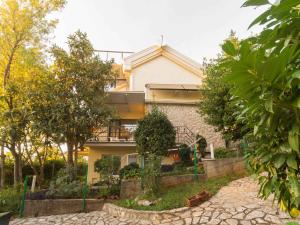 a house with a garden in front of it at Apartment in Njivice - Insel Krk 33553 in Njivice