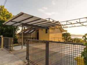 a building with awning in front of a fence at Apartment in Njivice - Insel Krk 33553 in Njivice
