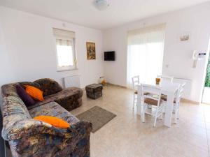 a living room with a couch and a table at Apartment in Njivice/Insel Krk 27658 in Njivice