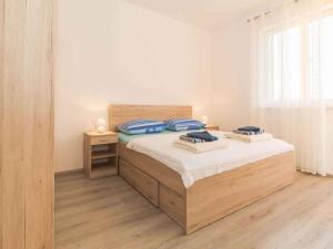 a bedroom with a bed with two pillows on it at Apartments in Njivice/Insel Krk 27657 in Njivice
