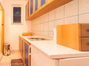 a kitchen with a white counter top and a refrigerator at Studio in Njivice/Insel Krk 27373 in Njivice