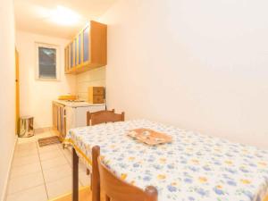 a kitchen with a table with a table cloth on it at Studio in Njivice/Insel Krk 27373 in Njivice