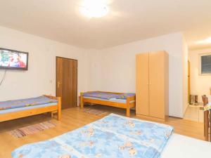 a room with two beds and a tv in it at Studio in Njivice/Insel Krk 27373 in Njivice