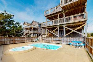 an apartment building with a pool and a balcony at Slow M'Ocean #7-HH in Hatteras
