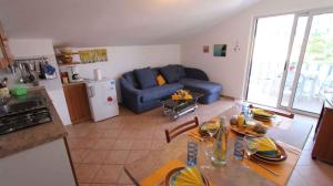 a kitchen and a living room with a blue couch at Apartment in Porat/Insel Krk 13205 in Porat