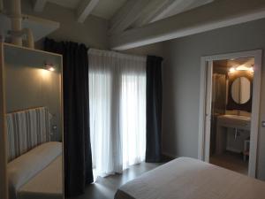 Postel nebo postele na pokoji v ubytování Corte Merighi Charming Rooms