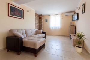 a living room with a couch and a table at Apartment in Porat/Insel Krk 13159 in Porat