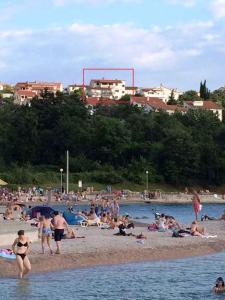 a group of people on a beach in the water at Apartment in Njivice/Insel Krk 13321 in Njivice