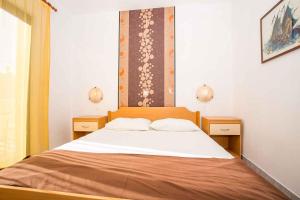 a bedroom with a large bed with two night stands at Apartment in Njivice/Insel Krk 13321 in Njivice